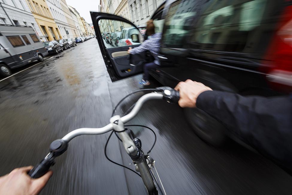 car door opening cyclist